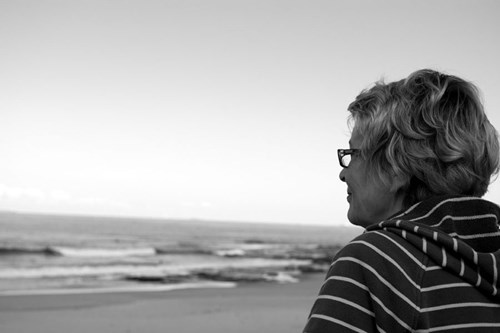 Anna, Kate's mum, looking at the beach smiling. 