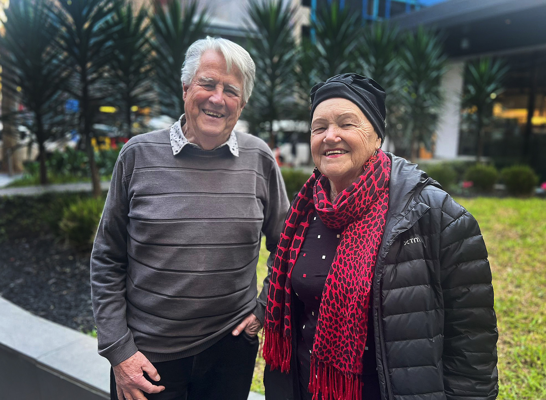 Ross and Marianne Allan, a husband and wife, standing side by side smiling. 