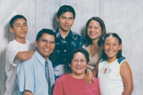 Sarah taking a portrait photograph with her family.