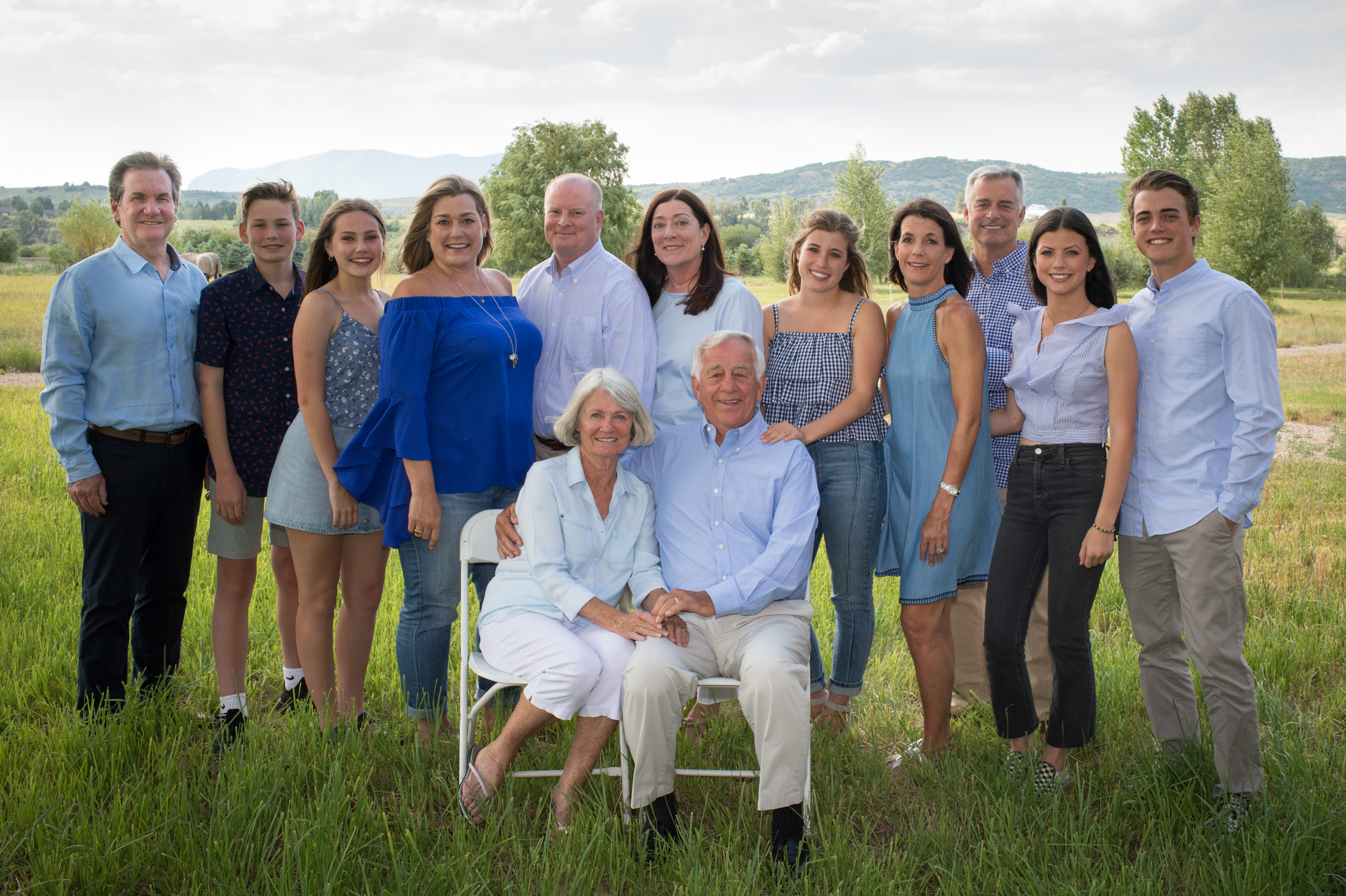 Kelly and Kathy taking a family photo in a field. 