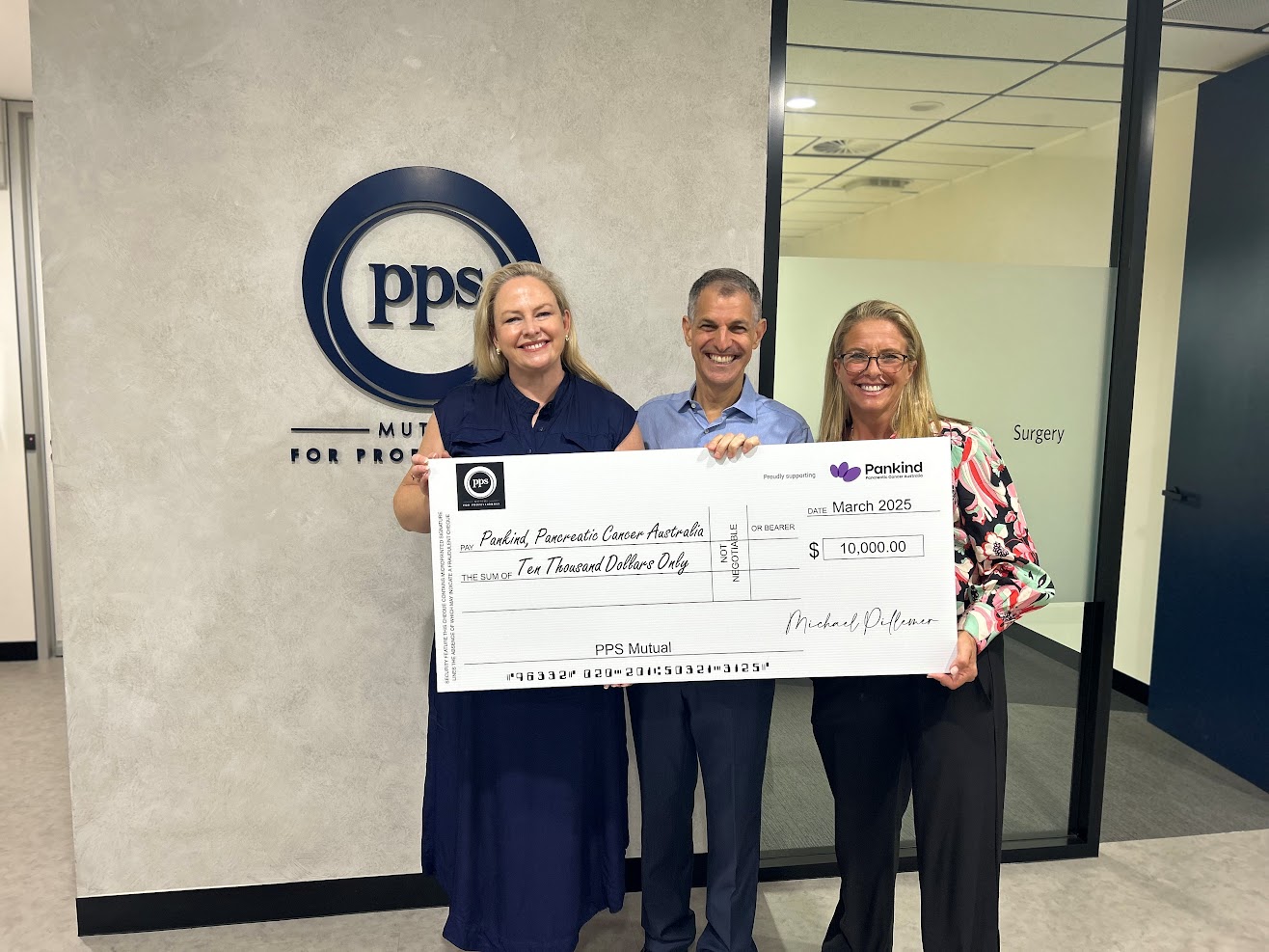 Pankind receiving a cheque from PPS Mutual