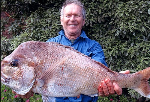 John holding a freshly caught fish.
