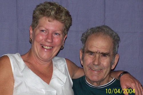 Joanne and her father Ray sitting together smiling. 